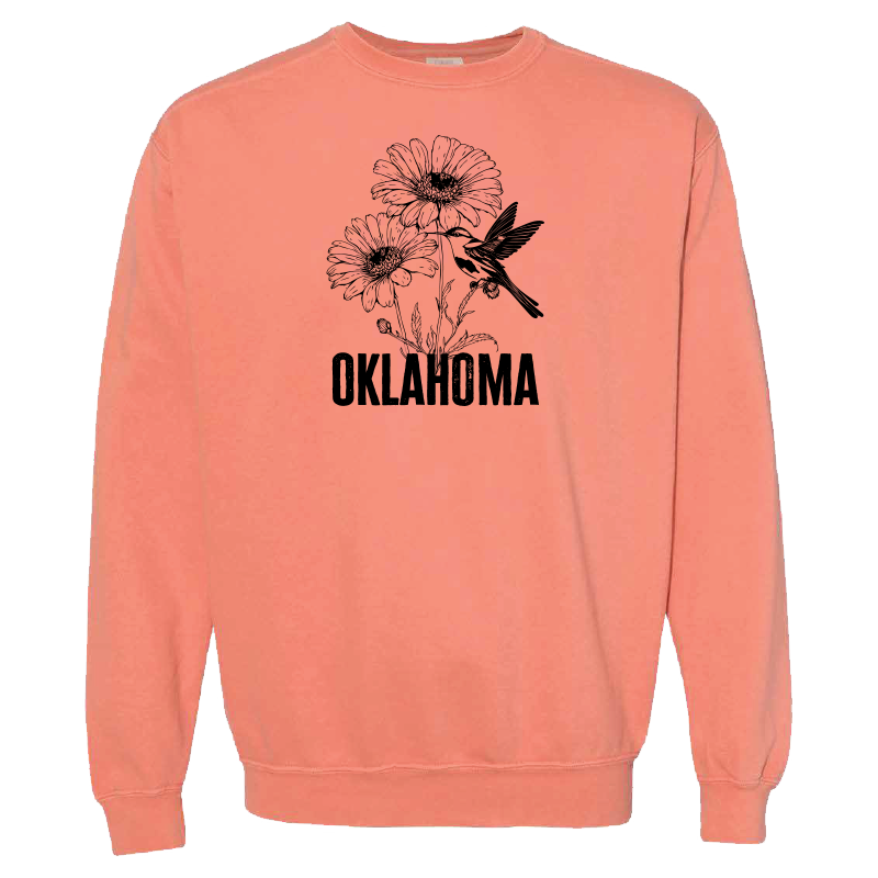 Terra cotta-colored sweatshirt. Graphic design: blanket flower with scissor-tailed flycatcher and "Oklahoma" in text.