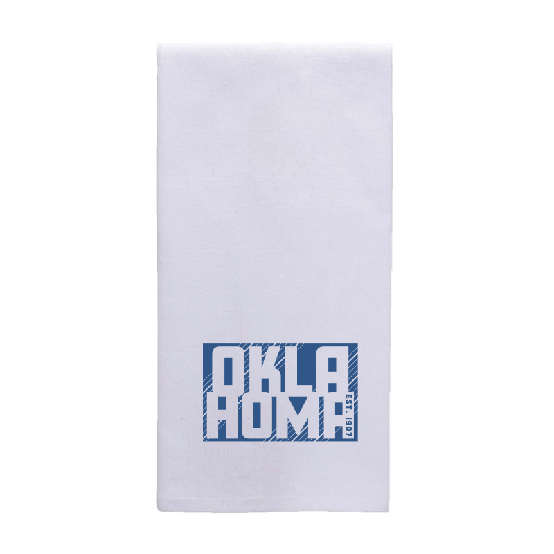 White tea towel featuring a blue graphic of the text "Oklahoma Est. 1907."